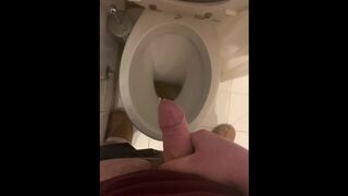 a guy pisses and then masturbates in the bathroom, cumming with his nice cock all over the place - 1 image
