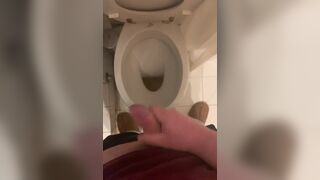 a guy pisses and then masturbates in the bathroom, cumming with his nice cock all over the place