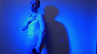 Kudoslong nude in a blue light playing with his flaccid cock