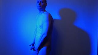 Kudoslong nude in a blue light playing with his flaccid cock - 4 image