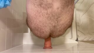 Top down view of dildo riding while standing in shower