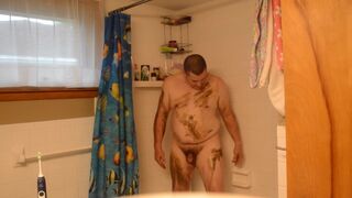 Getting cleaned up in the shower after getting very muddy and dirty - 2 image