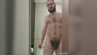 Chastity locked bear plays with his new tail toy