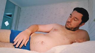 Hairy man stroking his thick uncut cock to cumshot