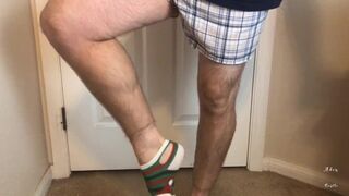 Man does Calf Flexing with X-Mas Socks