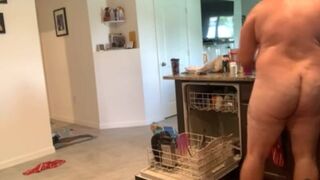 Dad bod naked man doing dishes