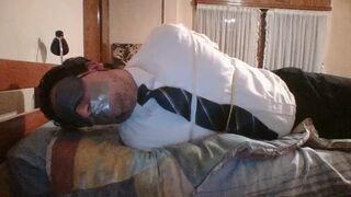 BUSINESSMAN MARTIN BLINDFOLDED, GAGGED & FASTENED IN DAYBED - 1 image