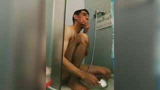 Spitting inexperienced athletic slender straight guy in tattoo takes a shower, washes his head legs penis in the bathroom toilet