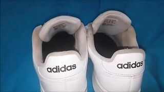 "A pair of white Adidas sneakers worn by a beautiful preppy girl." - 1 image