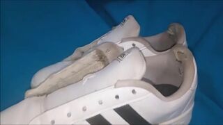 "A pair of white Adidas sneakers worn by a beautiful preppy girl." - 5 image