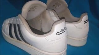 "A pair of white Adidas sneakers worn by a beautiful preppy girl." - 7 image