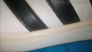 "A pair of white Adidas sneakers worn by a beautiful preppy girl." - 9 image