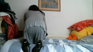 Italian designer boots and grey outfit on the bed