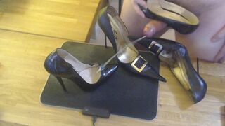 A guy masturbates with a high heel and cums on two pairs high heels