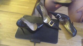 A guy masturbates with a high heel and cums on two pairs high heels