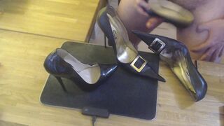 A guy masturbates with a high heel and cums on two pairs high heels
