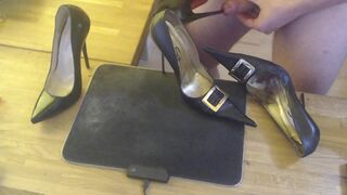 A guy masturbates with a high heel and cums on two pairs high heels