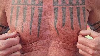 Playing with my nipples at the beach