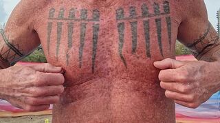 Playing with my nipples at the beach