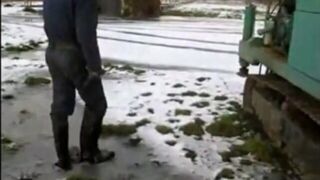 great guy in waders, rubber boots, mud and overall