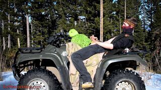 Biker fucks plush toy while on ATV four wheeler in the wilderness. - 1 image